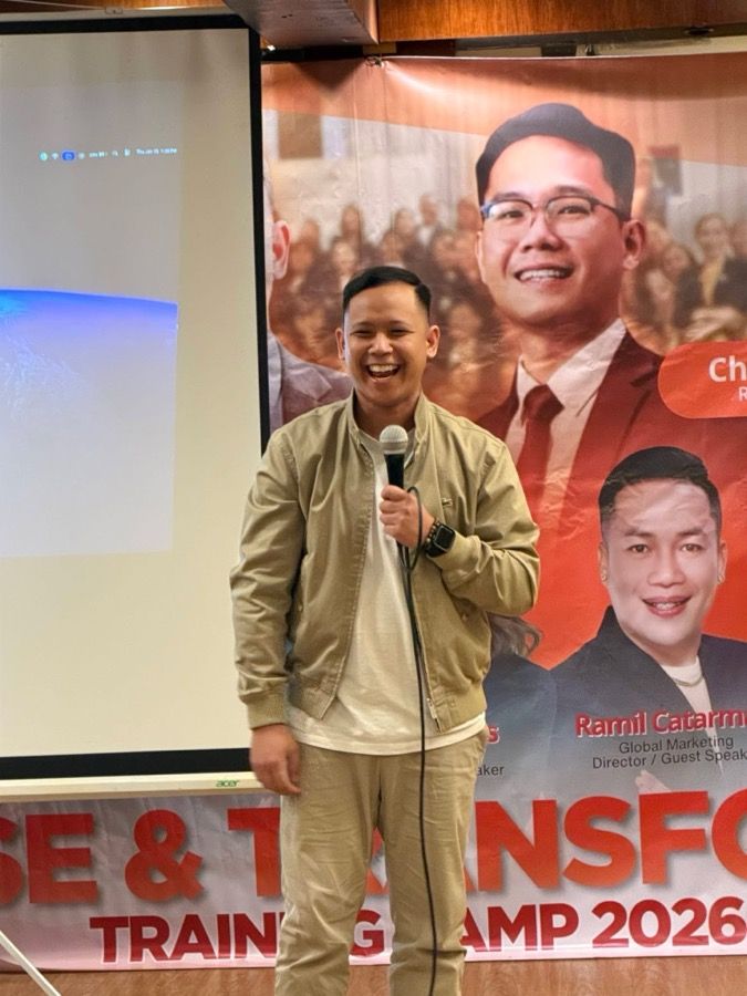 A facilitator on stage at a corporate training camp