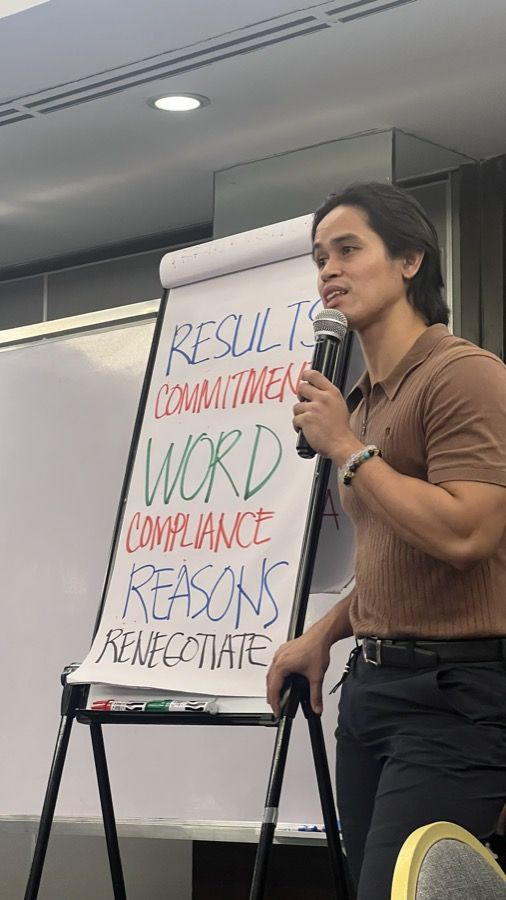 A facilitator unpacking commitments on a flip chart
