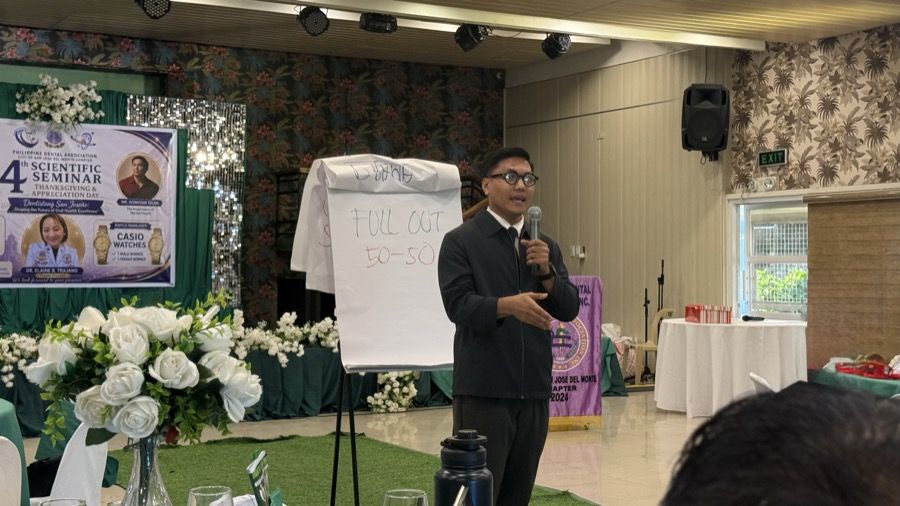 A facilitator presenting at a formal seminar