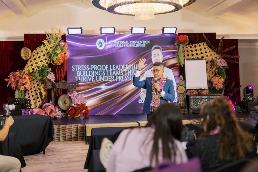 A SoulSync speaker on a leadership convention stage