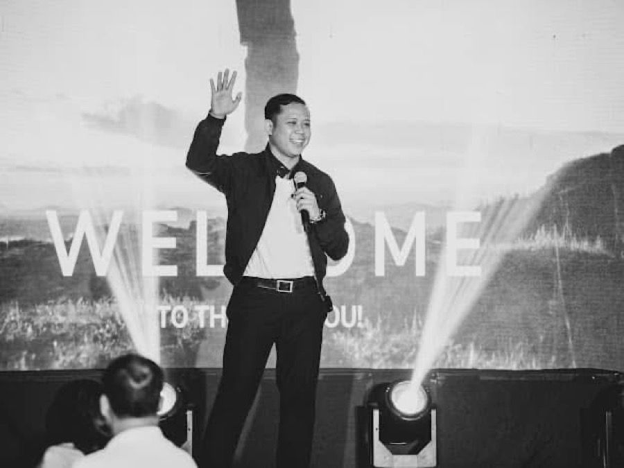 A SoulSync speaker welcoming participants on stage